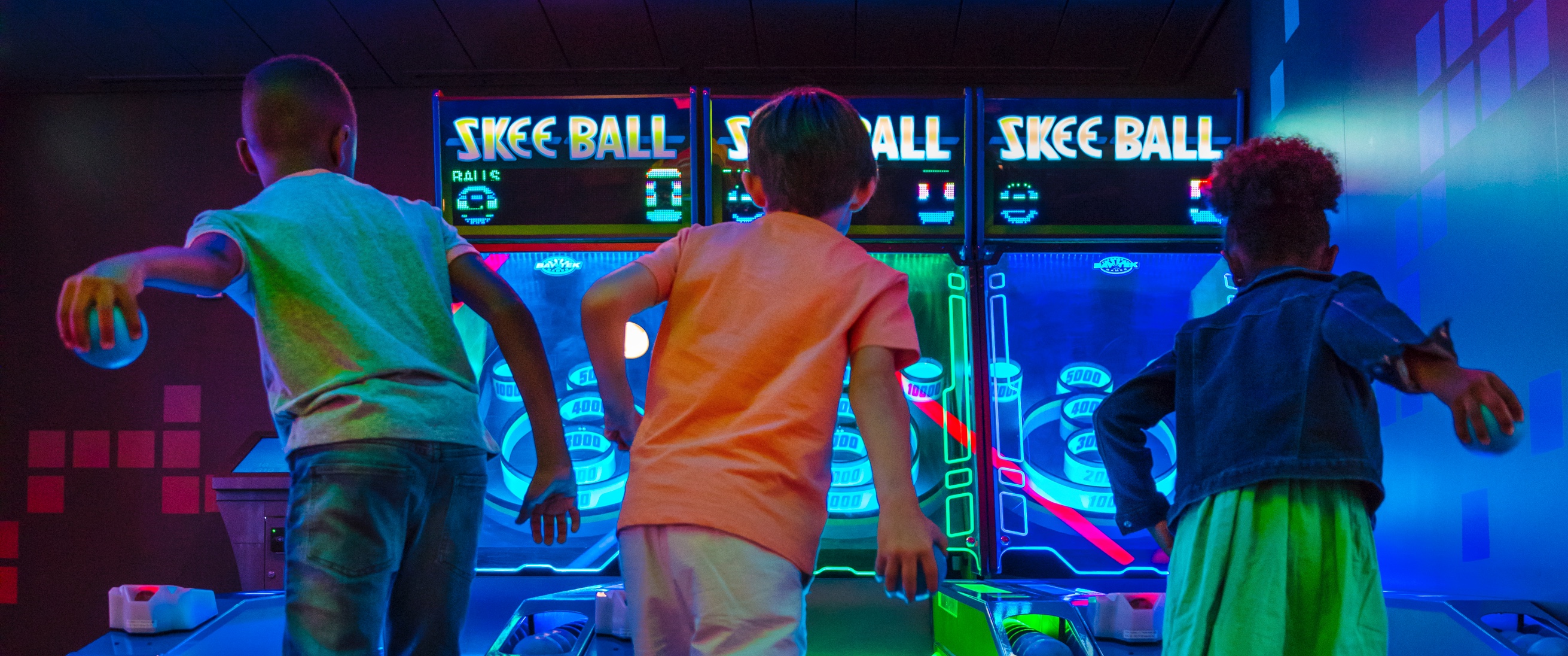 Kids Playing Skee Ball at the Playmakers Sports Arcade Bar.