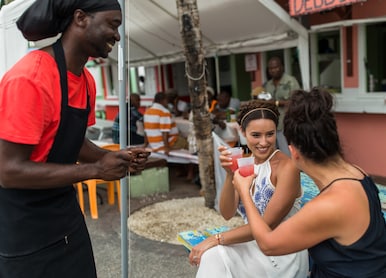 two girls cheers with local rum punch