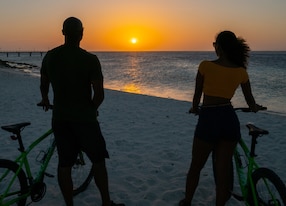 bicycles couple on the beach sunset