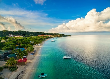 an aerial view of a tropical beach in roat n honduras early in the morning