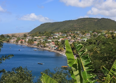 dominica coastline with small town hills and blue sky